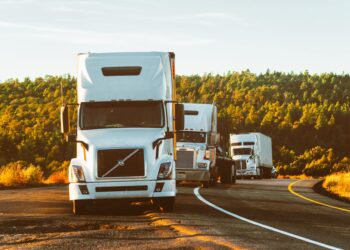 white volvo semi truck on side of road